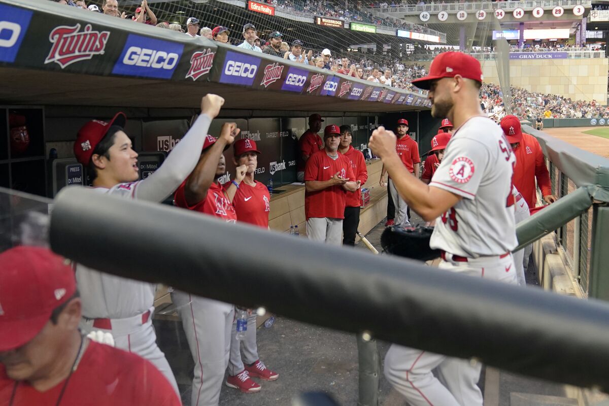 The Angels' Patrick Sandoval, right, is greeted by Shohei Ohtani in the dugout.