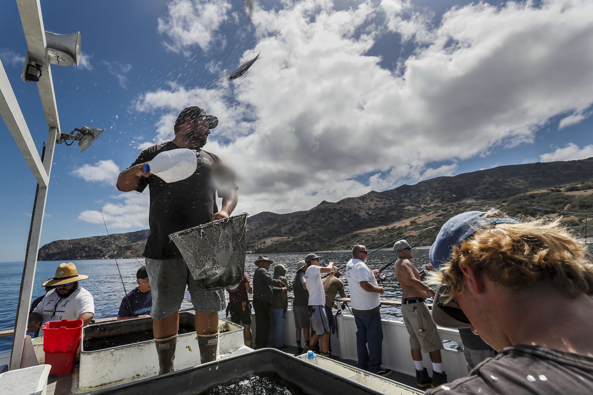 Sean Rubino, aka Bobby Hill, tosses baitfish into the water as fisherman on the Enterprise troll near Catalina Island