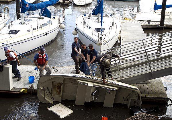 A group tries to save a tipped boat in Santa Cruz after the tsunami.