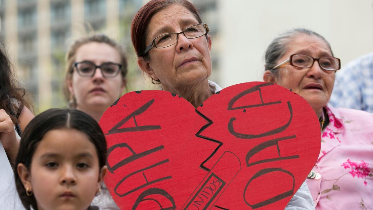 Angela Reyes holds a sign while participating in a vigil at the Governor's Mansion in Austin, Texas, on June 23 in response to the Supreme Court decision about President Obama's immigration executive order.