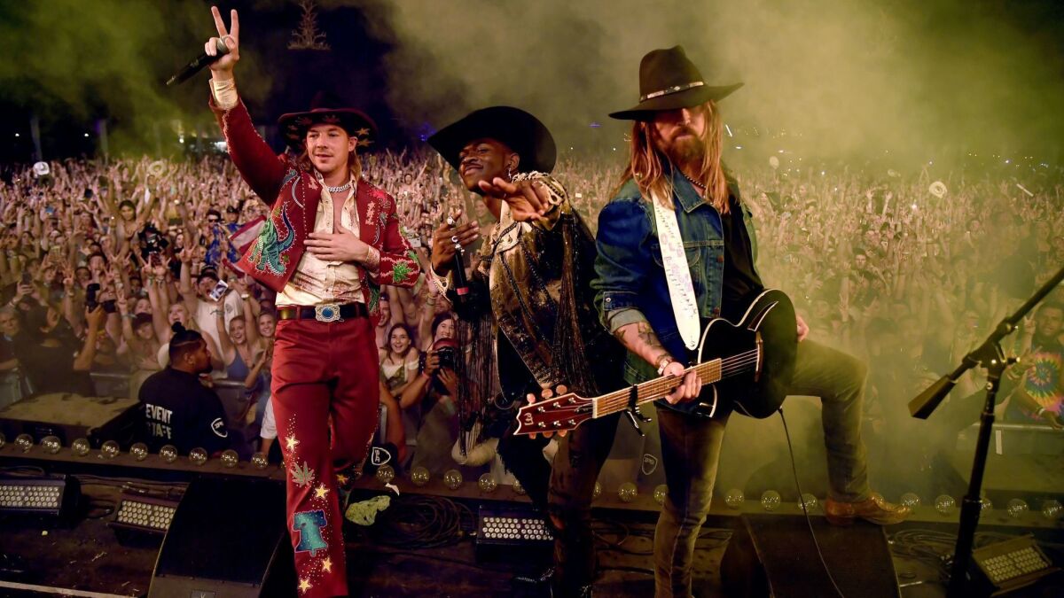 DJ Diplo, left, with Lil Nas X and Billy Ray Cyrus perform "Old Town Road" at the conclusion of the 2019 Stagecoach country music festival in Indio.