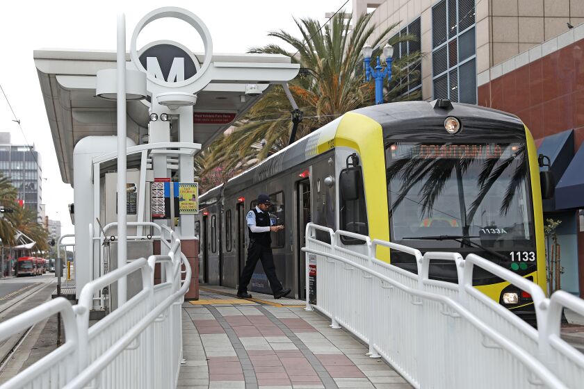 LONG BEACH, CA - APRIL 13: A conductor boards a metro car at the Blue Line Metro 1st Street station in downtown on Thursday, April 13, 2023 in Long Beach, CA. People using the Blue Line Metro station where a man was stabbed to death on April 12th at the 1st Street station around 3:38 p.m. (Gary Coronado / Los Angeles Times)