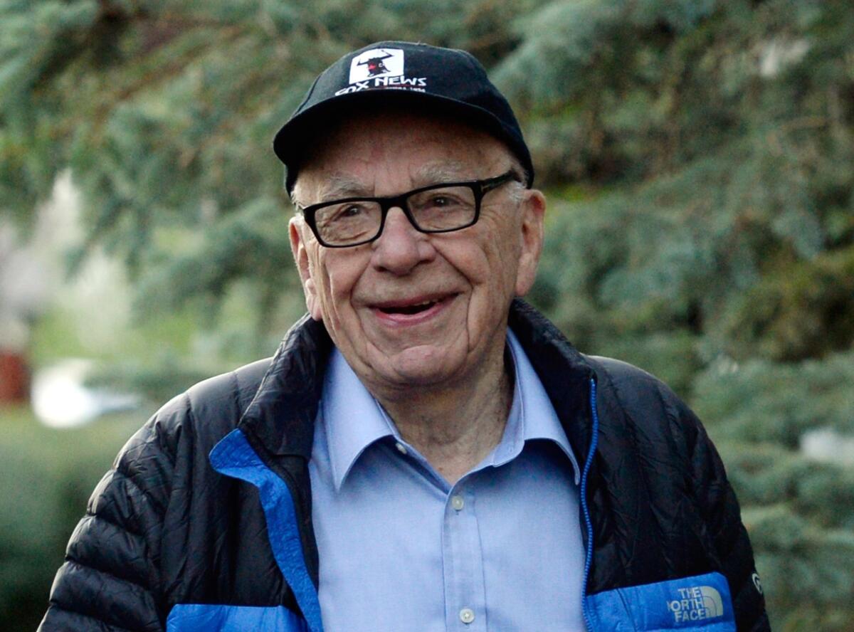 Rupert Murdoch's publishing company News Corp. said Thursday it would pay shareholders a semiannual cash dividend, its first since becoming a stand-alone company in 2013. Murdoch, who is chairman of News Corp., is pictured here in Sun Valley, Idaho, in July 2013.