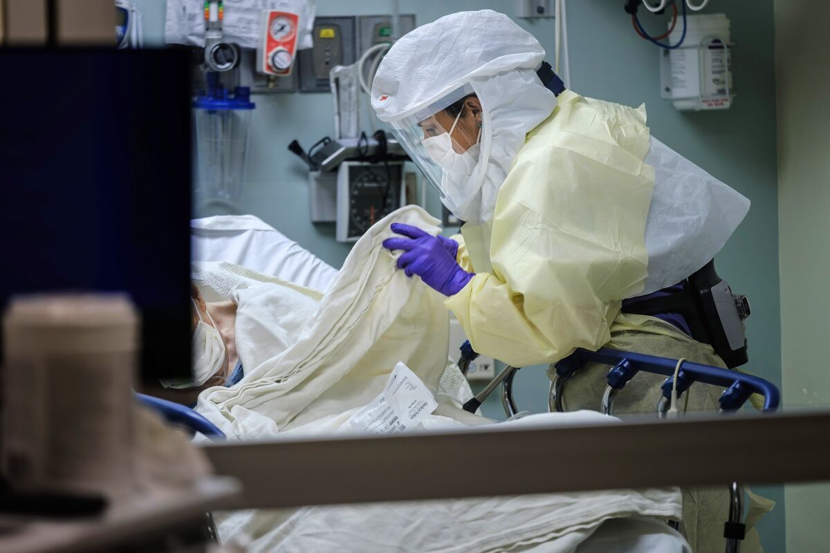 A nurse cares for a patient suspected of being infected with COVID-19 at a San Diego hospital in April.