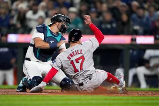 Seattle Mariners catcher Cal Raleigh can't get a tag on Boston Red Sox's Tyler O'Neill, who scored on a throwing error by Mariners third baseman Josh Rojas during the fourth inning of an opening-day baseball game Thursday, March 28, 2024, in Seattle. (AP Photo/Lindsey Wasson)