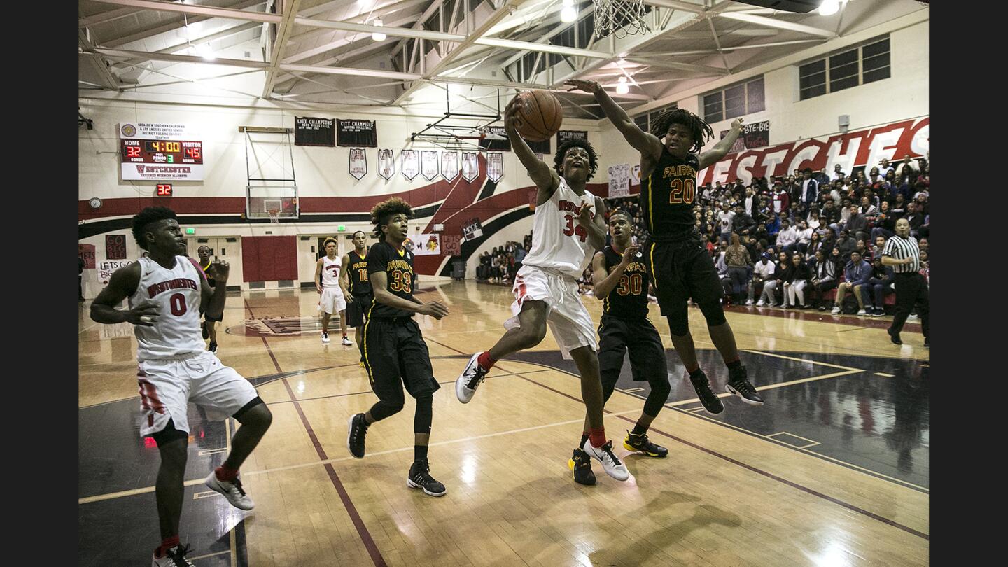 Westchester guard Darryn Everage (34) attempts a layup as Fairfax guard Ethan Anderson (20) challenges him during second half action at Westchester High School.