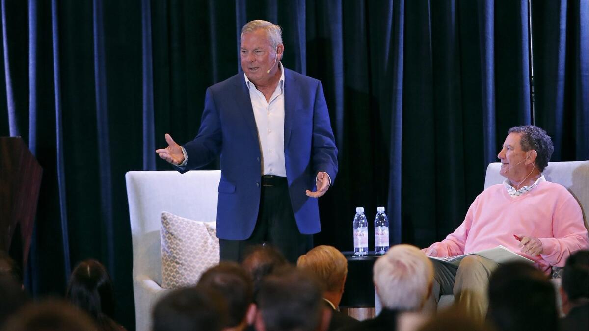 Lanny Wadkins, left, a 21-time PGA Tour winner, is welcomed to the stage with Hank Adler, right, chairman emeritus of the Toshiba Classic, during the tournament's Breakfast with a Champion event Tuesday at the Balboa Bay Resort in Newport Beach.