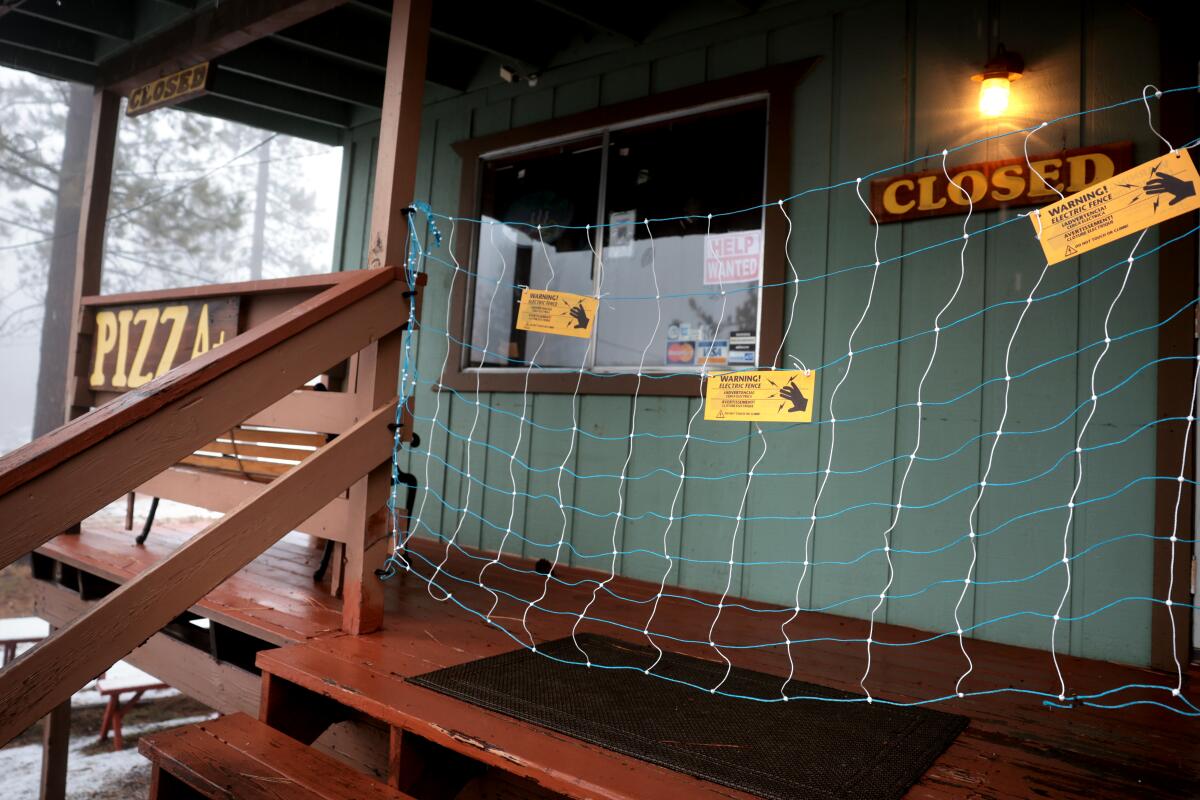 An electric fence hangs in front of Pine Mountain Pizza Company