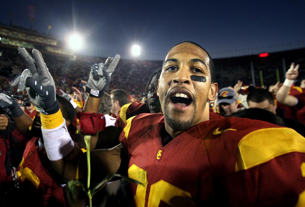 USC's Terrell Thomas celebrates with a rose after defeating UCLA at the Coliseum in 2007.