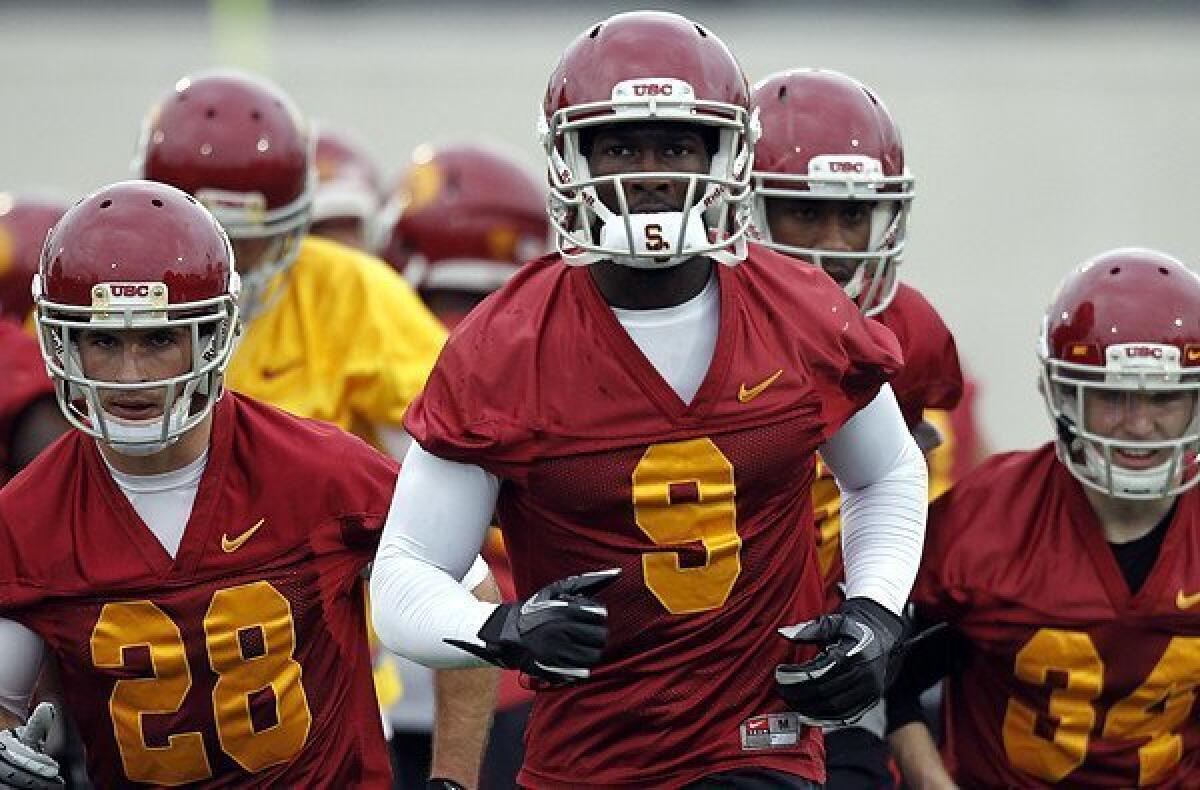 Receiver Marqise Lee and Trojans teammates take the field during spring practice at USC.