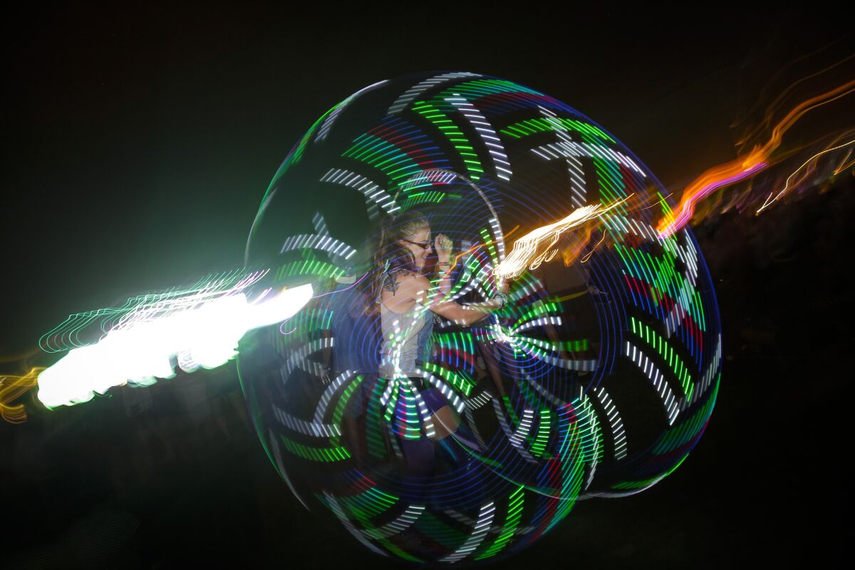 Cameron Doss, 24, performs hoop dancing during the OutKast performance to close the Main Stage, on the first day of the second weekend of the Coachella Valley Music and Arts Festival.