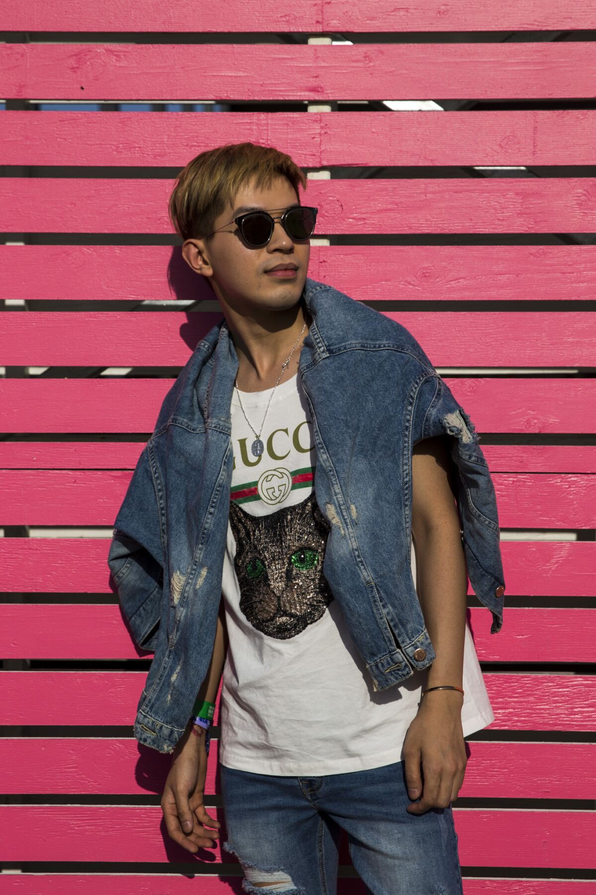 Jeremy Tong, 25, of London wears a Gucci logo t-shirt, featuring Mystic Cat, with denim and sunglasses during Day 1 of the 2018 Coachella Arts and Music Festival.
