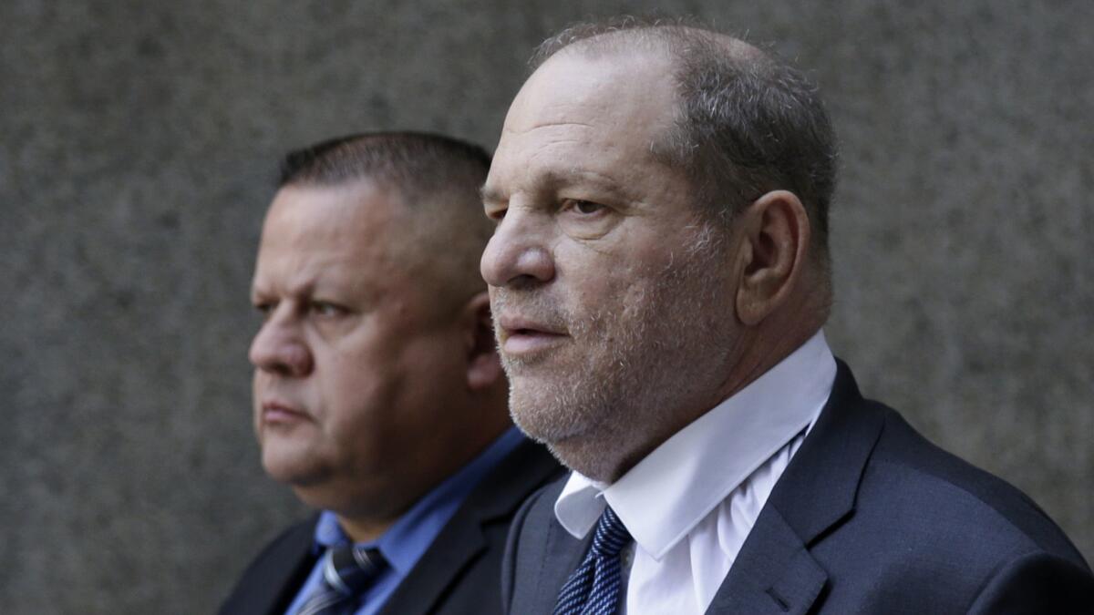 Former movie mogul Harvey Weinstein, right, leaves the New York State Supreme Court following a hearing related to his sexual assault case on Thursday.
