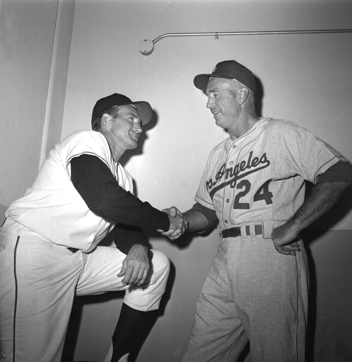 Giants manager Alvin Dark, left, and Dodgers manager Walter Alston shake hands.