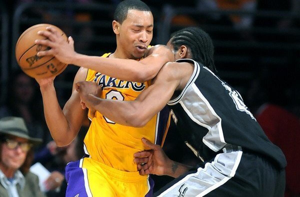 Lakers guard Andrew Goudelock protects the ball as Spurs forward Kawhi Leonard plays tight defense in Game 3 on Friday night.
