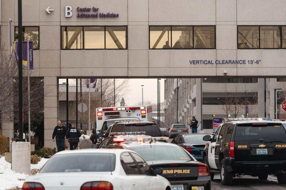 Officers gather in front of the Renown Regional Medical Center this month after a gunman killed a doctor, wounded two people and then killed himself.