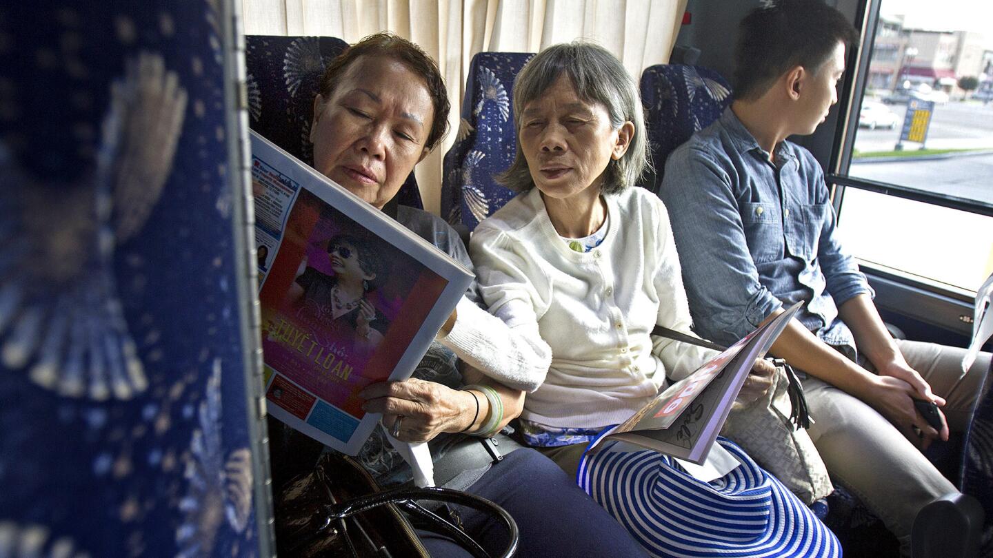 Tran Thu Huong, from left, Le Thi Tam and Edmund Florendo aboard the Xe Do Hoang bus. In a culture where people tend to show up when they want to show up, the punctuality of this bus line stands out.