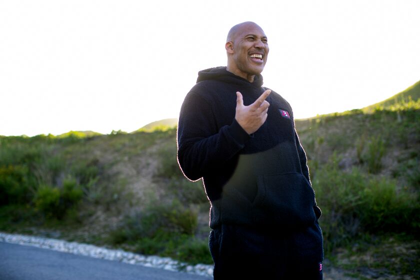 CHINO HILLS, CA - MARCH 16, 2021: LaVar Ball stands on what was once a dirt path where he use to train his sons in their early years at Chino Hills State Park on March 16, 2021 in Chino Hills, California. The basketball playing Ball brothers Lonzo, LiAngelo and LaMelo are all expected to play in the NBA this year and put Chino Hills on the map for the rest of the nation.(Gina Ferazzi / Los Angeles Times)