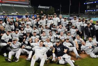 New York Yankees players pose for a team picture after Game 5 of the baseball AL Championship Series.