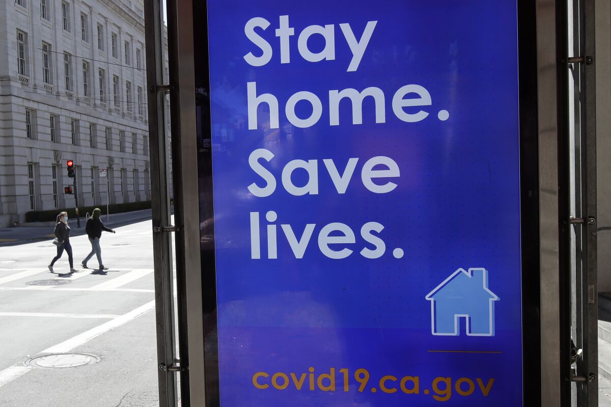A sign advising people to stay home due to COVID-19 concerns is shown at a MUNI bus stop in San Francisco, Thursday, April 2, 2020.