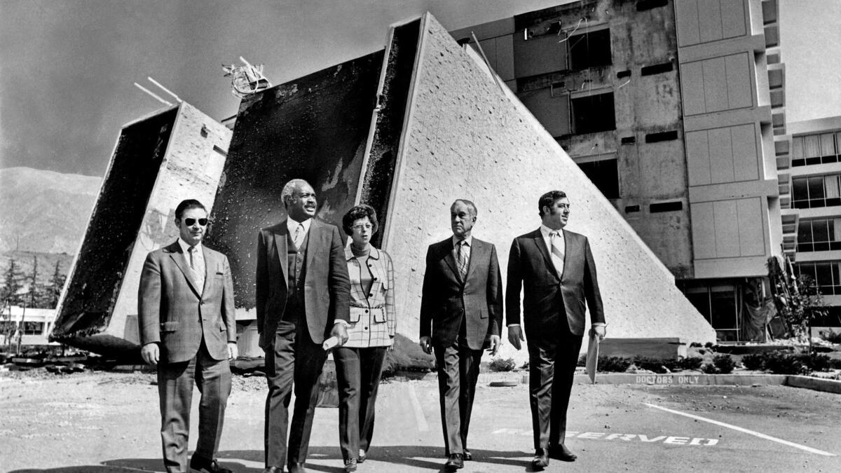 Touring the quake destruction at Olive View Hospital are, from left, health commissioners Marvin. E. Tincher, vice chairman; Dr. Maceo Broxton, Sr., Mrs. Merwin S. Kendis, president; N.M. Reeves and Edward Gendel. Scanned 10/1/2013.