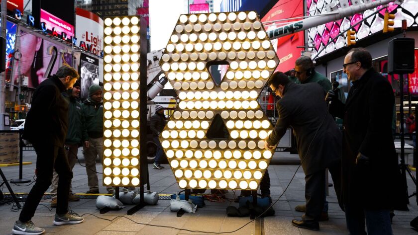 You can reserve a booth for six overlooking Times Square for $12,000 on New Year's Eve. Here, workers deliver the lighted "2018" that will be part of New York City's famous ball drop.