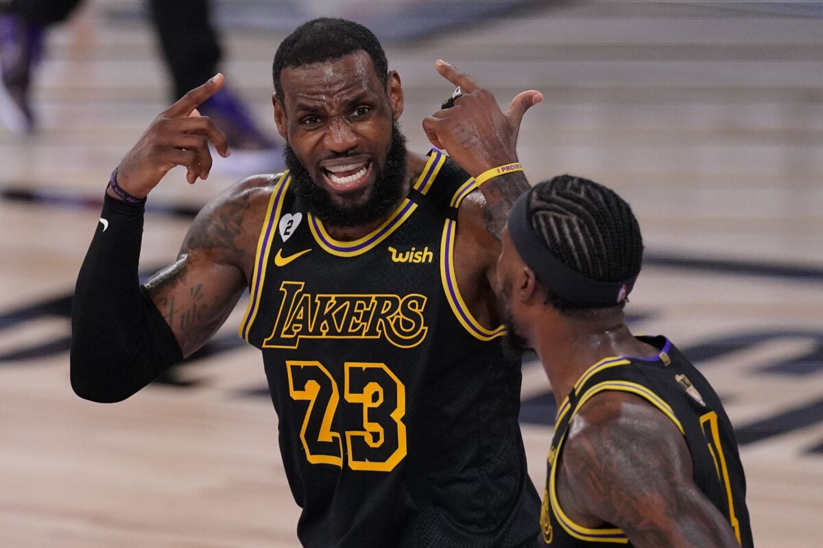 Lakers forward LeBron James talks with guard Kentavious Caldwell-Pope during the first half in Game 5.