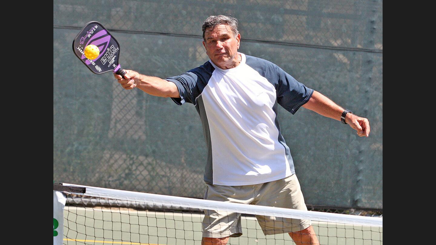 Jim Sartoriss, of Burbank, hits a return in a doubles match with his partner Dee Dee Jackson, of North Hollywood (not in picture) in the Burbank Pickleball Red White and Blue Doubles Tournament of 2017 at Larry L. Maxam Memorial Park in Burbank on Monday, July 3, 2017. This is the first tournament with hopes it will be annual.