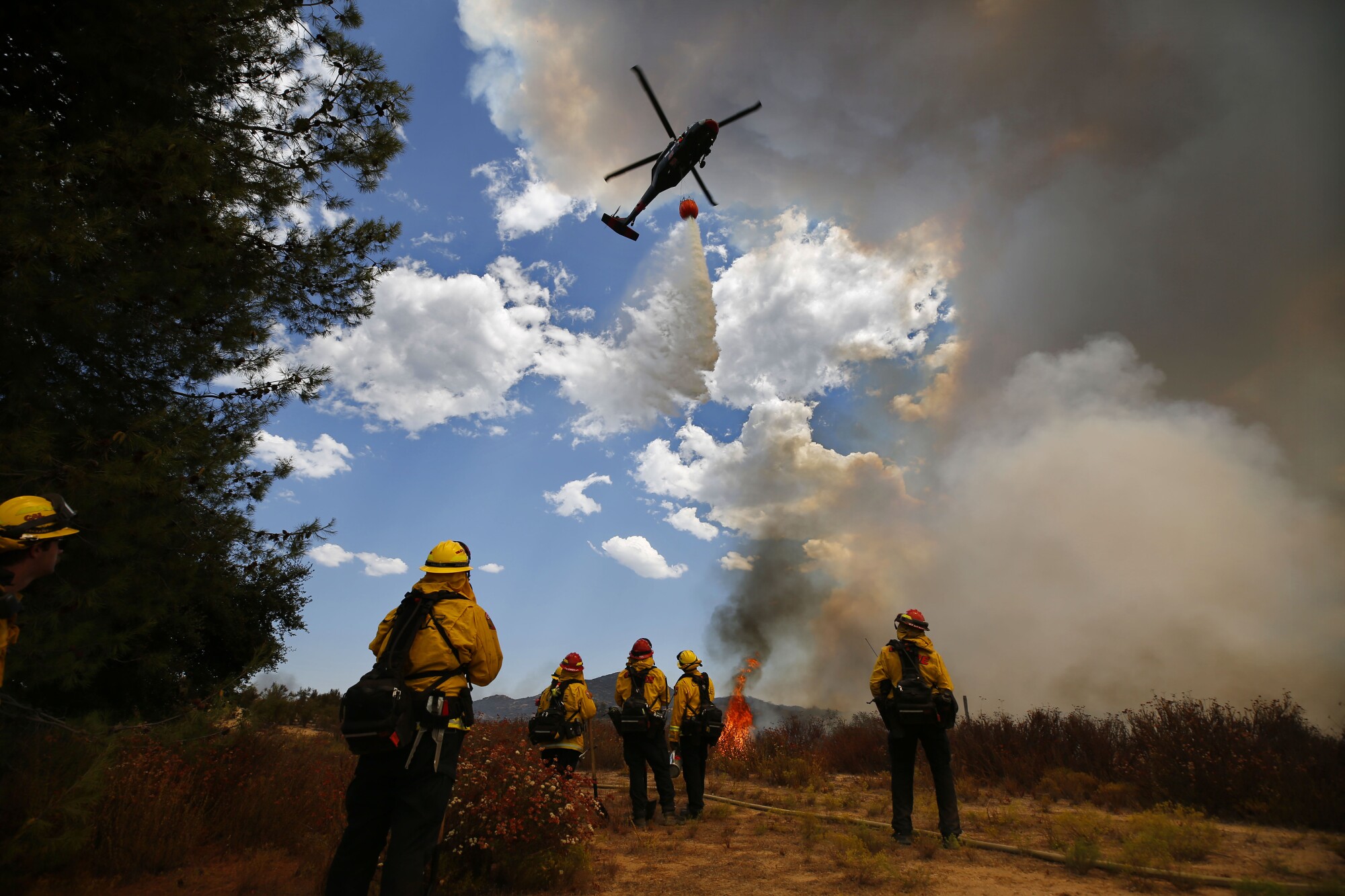 A helicopter makes a drop near on Montiel Truck Trail during the Valley fire on Sunday, Sept. 6, 2020