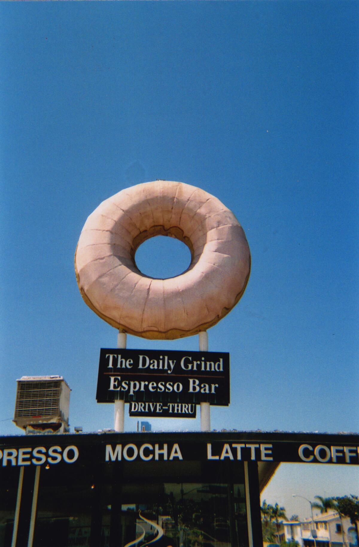Fans of a giant doughnut structure atop a cafe sign in Long Beach have succeeded in convincing new owner Dunkin' Donuts to keep the local landmark.
