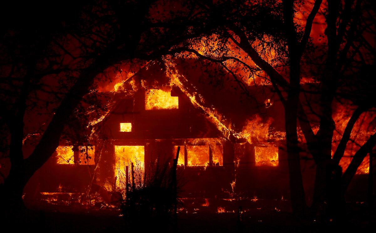 A ranch house along State Highway 128 near Healdsburg is consumed by the Kincade fire early Sunday morning.