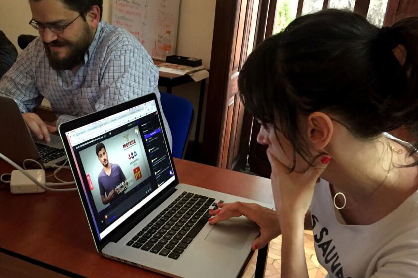 Alba Mora Roca, right, a journalist with Verificado 18, works on a video at the group's Mexico City office April 9, 2018. The group's staff is fact-checking fake news ahead of Mexico's July 1 presidential vote, publishing counter-content that shows exactly how facts, photos and videos have been manipulated.