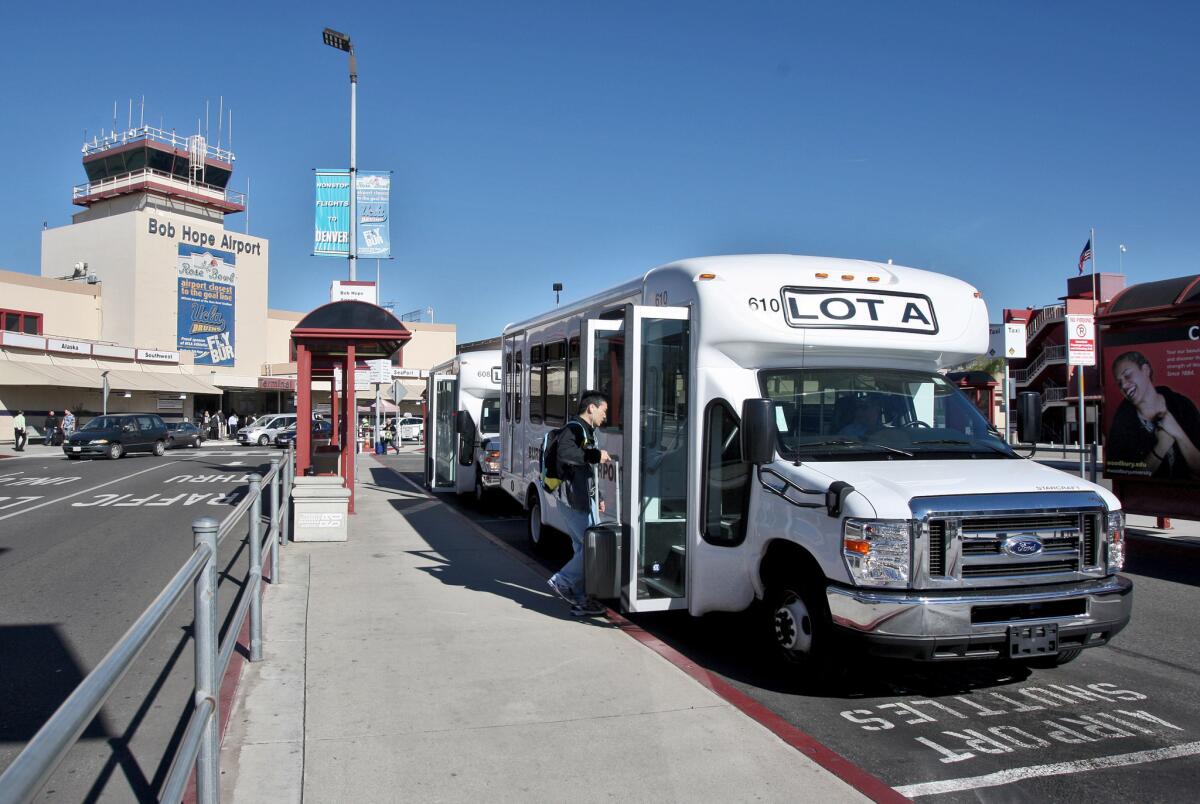 An airport shuttle picks up a passenger headed to Lot A from the Bob Hope Airport in Burbank on Tuesday, November 17, 2015. On Monday, airport officials inaugurated the airport’s new fleet of 13 compressed-natural-gas shuttle buses with a ride on one of the vehicles, each of which seats 14 passengers and can accommodate two wheelchairs.