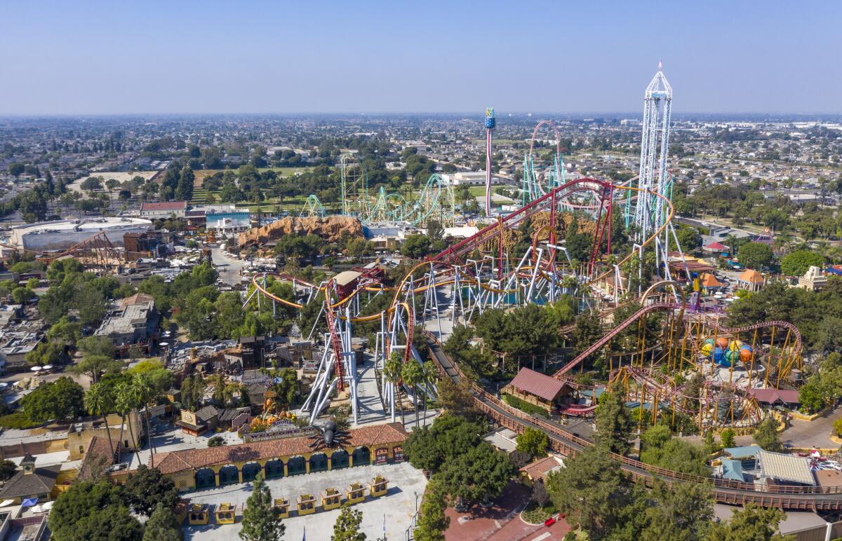 An aerial view of multiple roller coasters at a theme park.