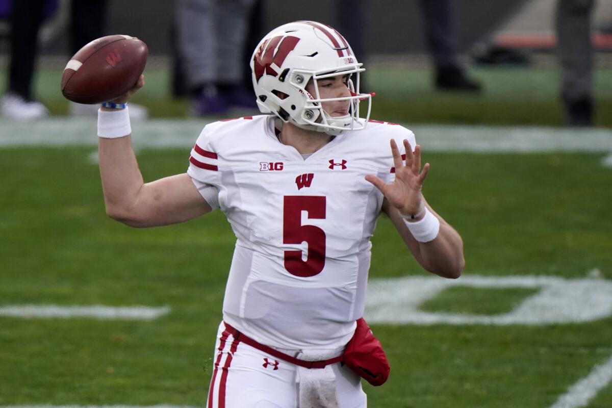Wisconsin quarterback Graham Mertz throws a pass during the first half of an NCAA college football game against Northwestern in Evanston, Ill., Saturday, Nov. 21, 2020. (AP Photo/Nam Y. Huh)