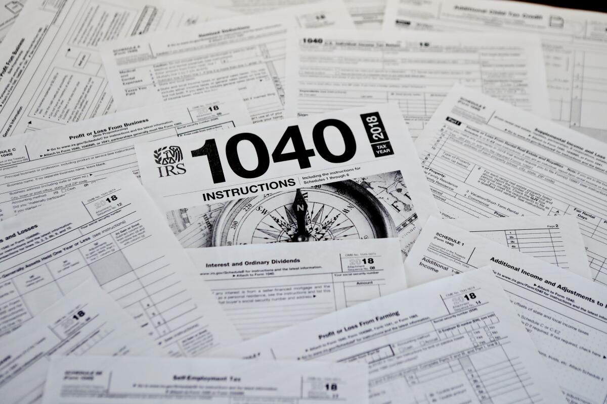 A spread out pile of tax papers with a 1040 form in the center