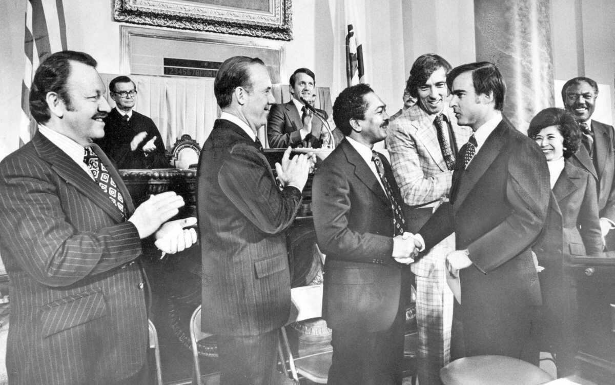 Jerry Brown shakes hands with Lt. Gov. Mervyn Dymally before being sworn in as governor in 1975.