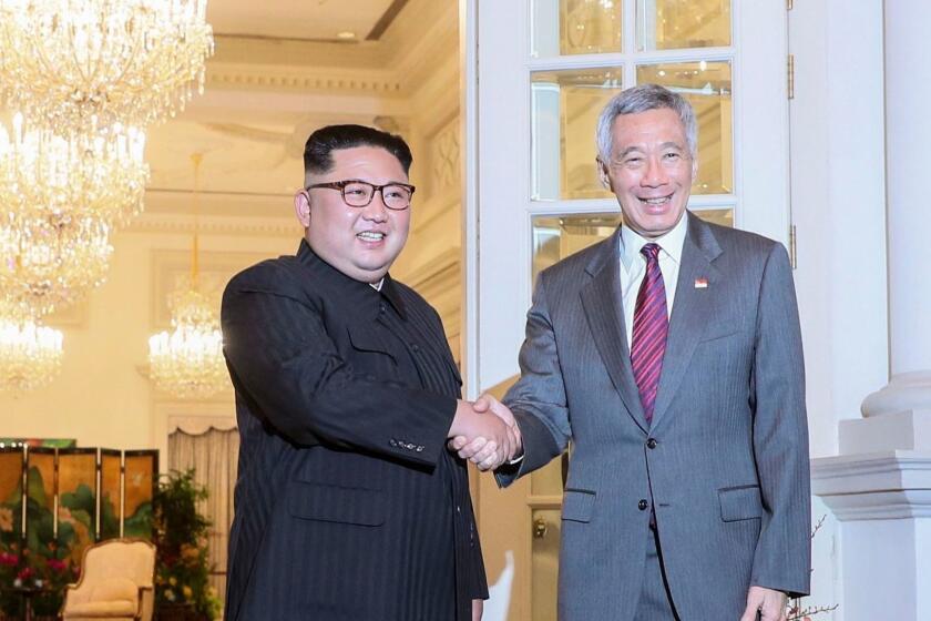 Mandatory Credit: Photo by WALLACE WOON/EPA-EFE/REX/Shutterstock (9708867al) Kim Jong-un and Lee Hsien Loong US North Korea Summit in Singapore - 10 Jun 2018 North Korean leader Kim Jong-un (L) and Singapore Prime Minister Lee Hsien Loong (R) shake hands during their meeting at the Istana Presidential Palace in Singapore, 10 June 2018. US President Donald J. Trump and North Korean leader Kim Jong-un are scheduled to meet at the Capella Hotel for an historic summit on 12 June 2018. ** Usable by LA, CT and MoD ONLY **