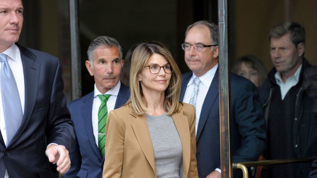 Actress Lori Loughlin exits a Boston courthouse after facing charges in the college admissions scandal on April 3.
