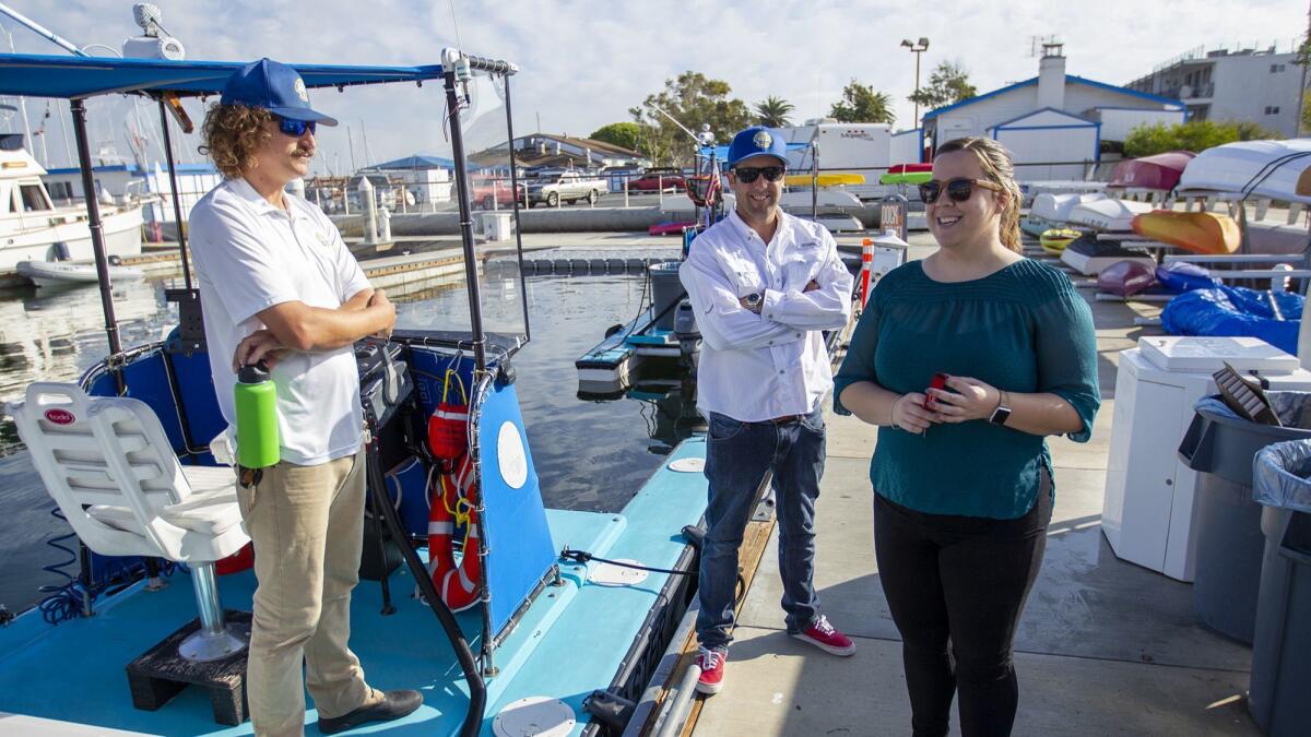 Auctioneer Jessica Allen opens Tuesday's auction for three impounded boats in Newport Beach. She promptly closed the auction when no one bid on the dilapidated vessels.