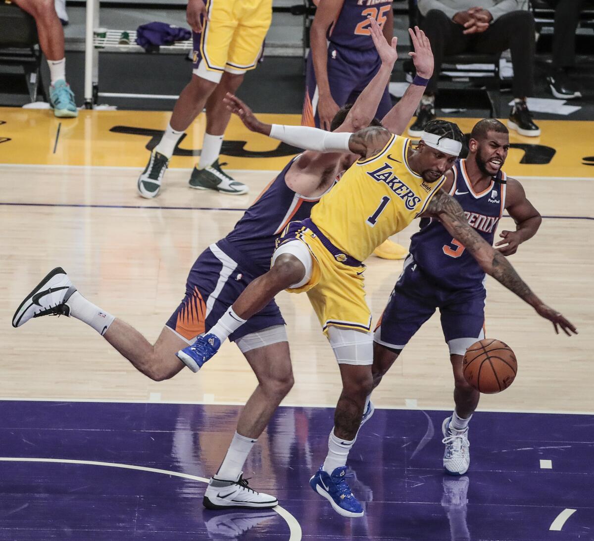 Lakers' Kentavious Caldwell-Pope is stripped of the ball by Phoenix Suns' Chris Paul as he bumps into Dario Saric.