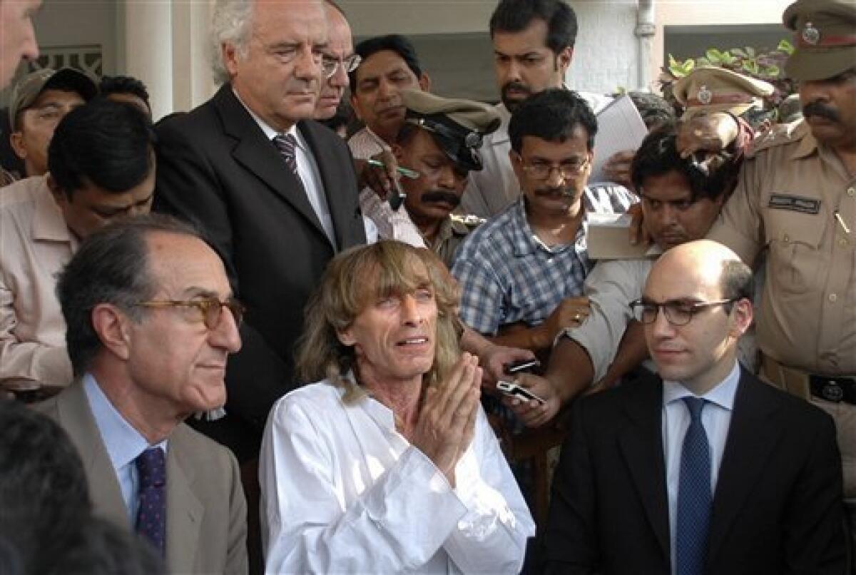 Italian tourist guide Paulo Bosusco, center, who was abducted by Maoist rebels more than a month ago, talks to the media, as unidentified Italian officials sit near him outside the state guest house in the eastern Indian city of Bhubaneswar, India, Thursday, April 12, 2012. Maoist rebels on Thursday released Bosusco from a remote forest area of eastern India after the state government agreed to release five rebels from prison. Basusco, along with Italian tourist Claudio Colangelo, was abducted on March 14 while on a trek in Orissa state. Colangelo was released 11 days later, but Basusco remained in captivity while negotiations took place between the rebels and the government. (AP Photo)
