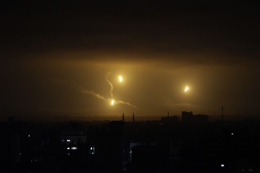 Flares light up the sky over Gaza City early Friday, before the cease-fire was to take effect.