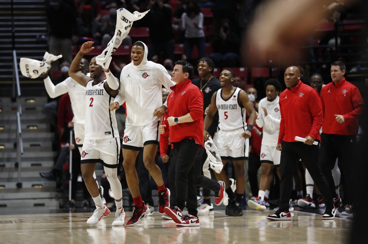 The San Diego State bench celebrates after a three pointer by Matt Bradley against Utah State.