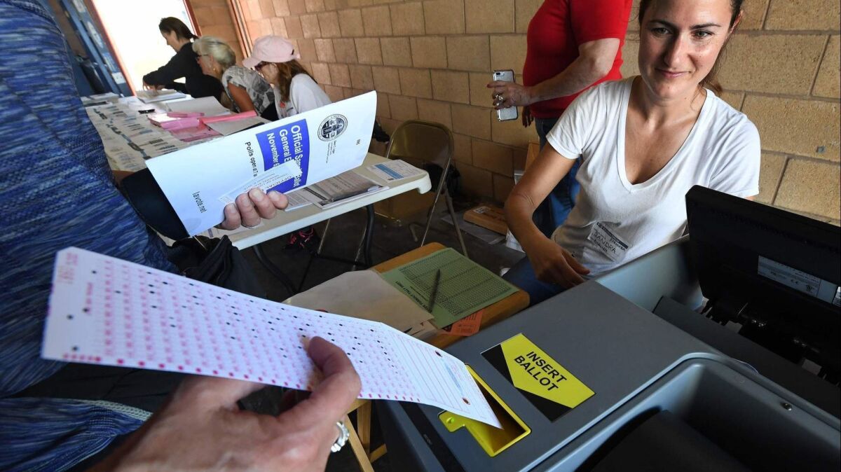 A woman votes in Hermosa Beach on Tuesday. California voters considered 11 statewide ballot measures, on topics ranging from rent control to daylight saving time.