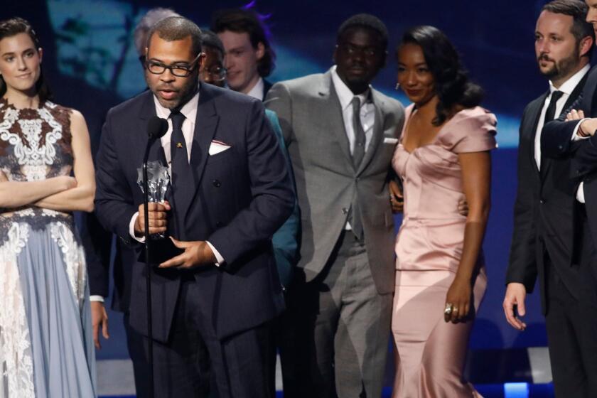 SANTA MONICA, CA - JANUARY 11, 2018 -- Jordan Peele gives the acceptance speech after winning the Best SciFi/Horror Movie award for his film, "Get Out," with members of the cast and crew stand behind him during the 23rd Annual Critics' Choice Awards inside the Barker Hangar in Santa Monica on January 11, 2018. (Genaro Molina / Los Angeles Times)