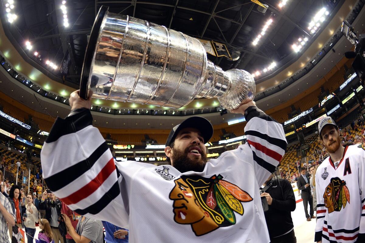 Blackhawks goalie Corey Crawford celebrates with the Stanley Cup following Chicago's 3-2 victory over the Boston Bruins in Game 6 of the Stanley Cup Final.