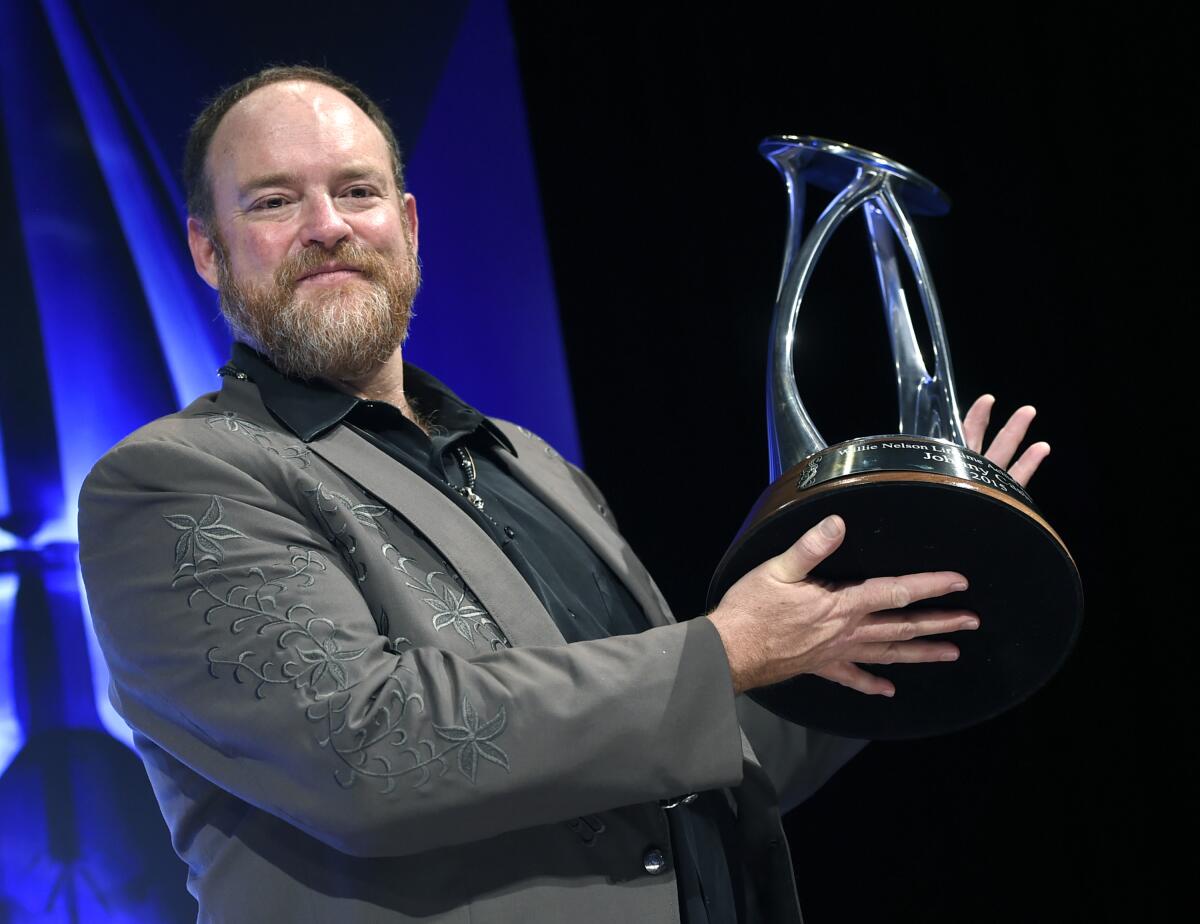 John Carter Cash holds an award bestowed on his later father Johnny Cash in 2015.