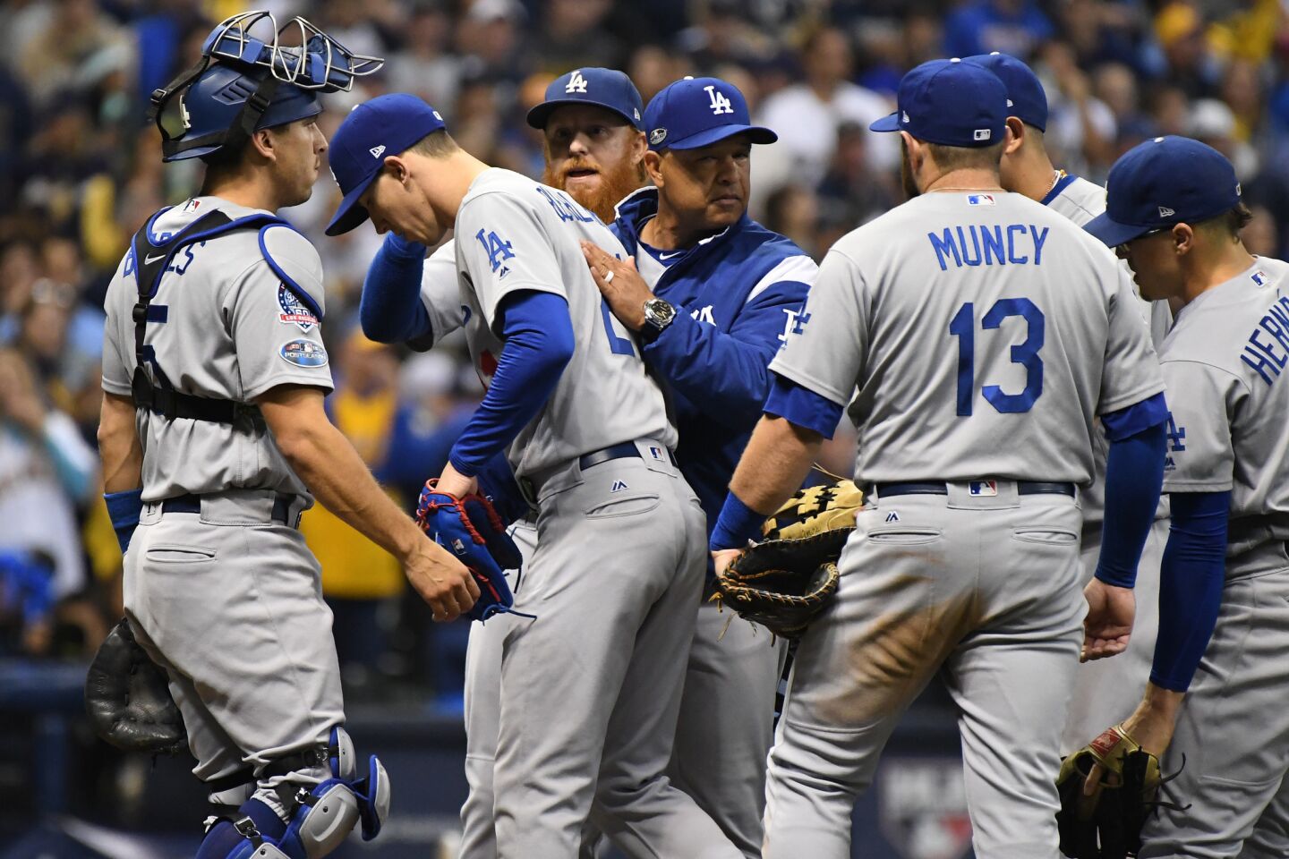 Dodgers manager Dave Roberts pats Walker Buehler after taking him out of the game in the fifth inning.