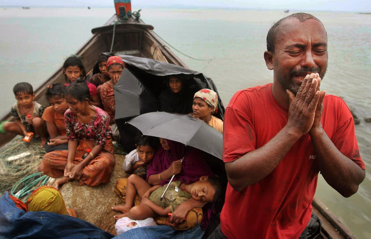 A Rohingya Muslim man who fled Myanmar to Bangladesh to escape religious violence cries as he pleads from a boat after he and others were intercepted by Bangladeshi border authorities in Taknaf, Bangladesh, in June 2012. Bangladesh had been returning thousands of Rohingya Muslims, according to human rights groups.